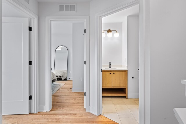 2251 Trillium Ln, Ann Arbor, MI 48104 - corridor featuring a sink and light wood-style floors