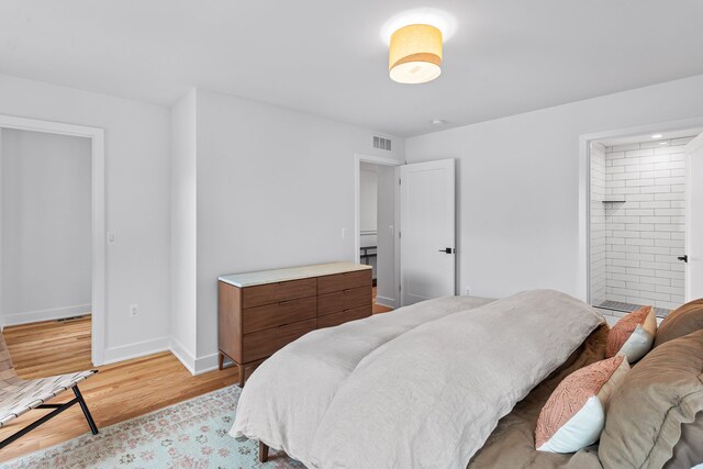 2251 Trillium Ln, Ann Arbor, MI 48104 - bedroom with light wood-style floors, baseboards, and ensuite bathroom