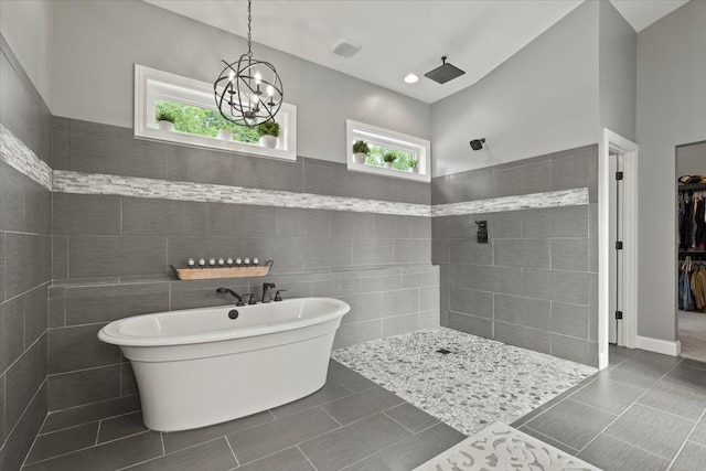 bathroom featuring a chandelier, tile walls, and shower with separate bathtub