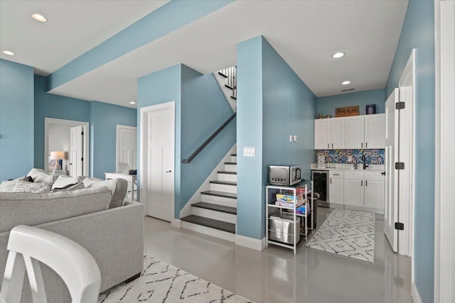 interior space featuring concrete flooring and beverage cooler