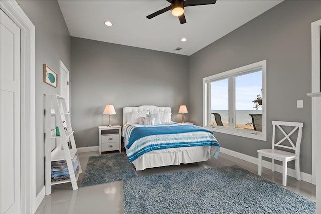 bedroom with wood-type flooring, a water view, and ceiling fan