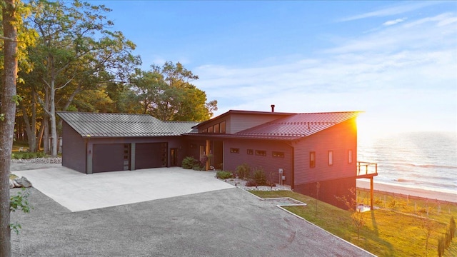 view of front of home with a water view and a garage