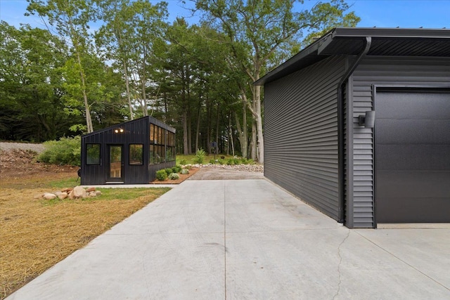 view of home's exterior with a garage and an outdoor structure