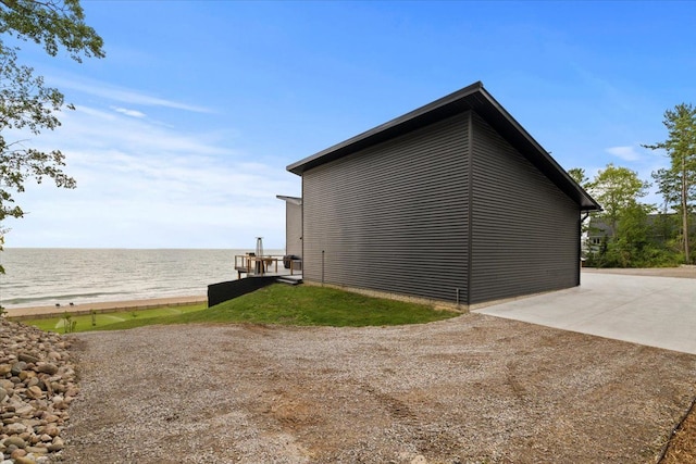 view of property exterior featuring a water view