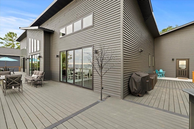 wooden deck featuring outdoor lounge area and grilling area