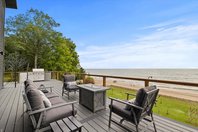 wooden terrace featuring area for grilling, outdoor lounge area, a water view, and a beach view