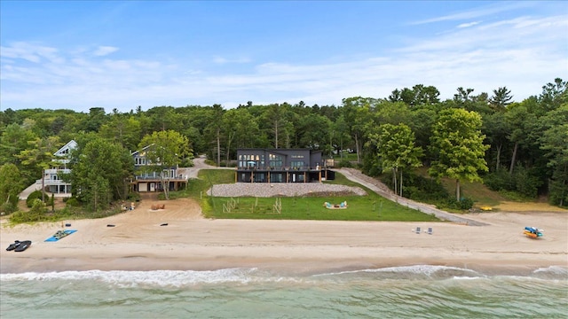 drone / aerial view featuring a water view and a beach view