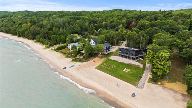 bird's eye view with a water view and a beach view