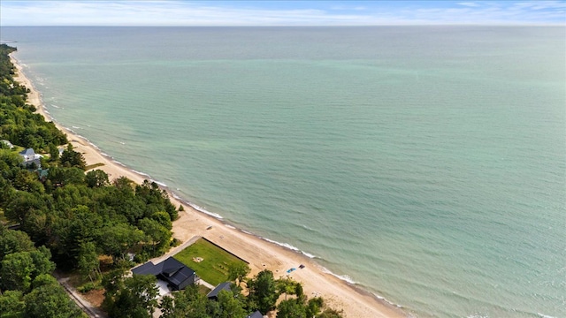 drone / aerial view featuring a water view and a beach view