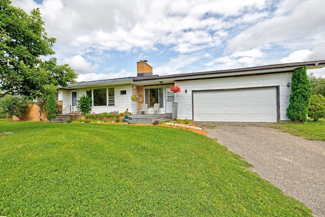 ranch-style home with a garage and a front yard