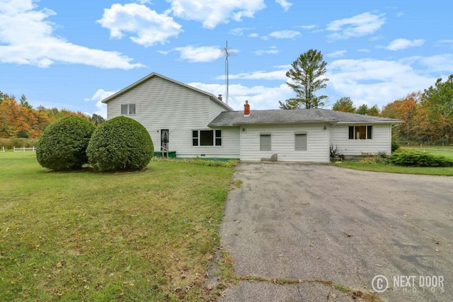 back of property featuring a lawn