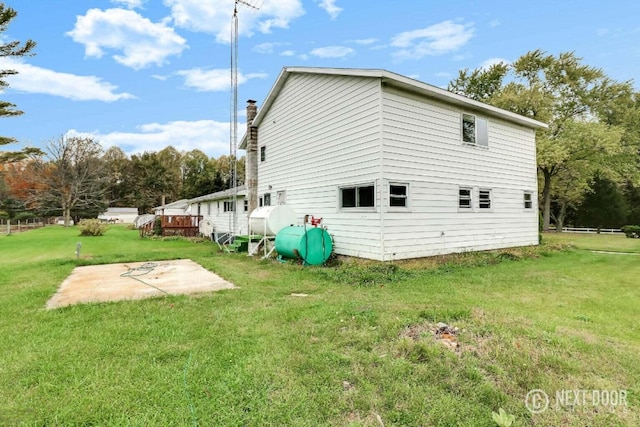 view of home's exterior with a yard and a patio area