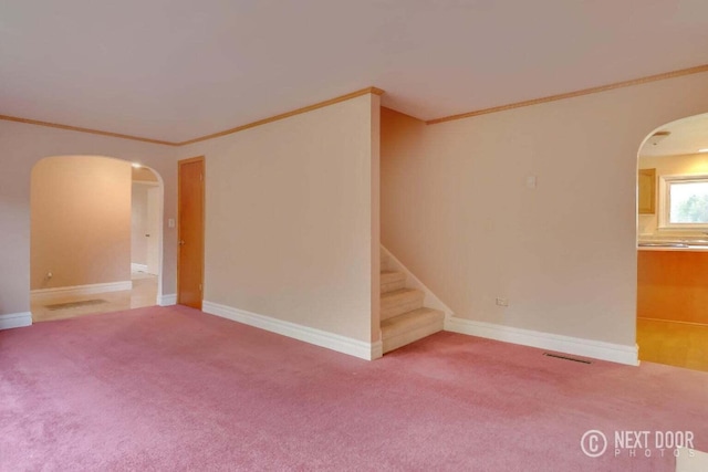 unfurnished room with carpet flooring and crown molding