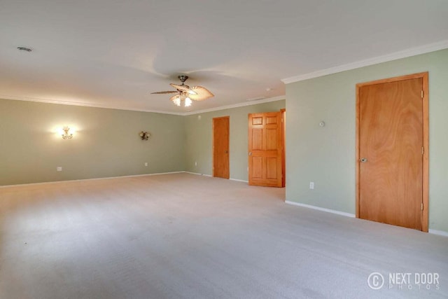 carpeted spare room with ceiling fan and ornamental molding