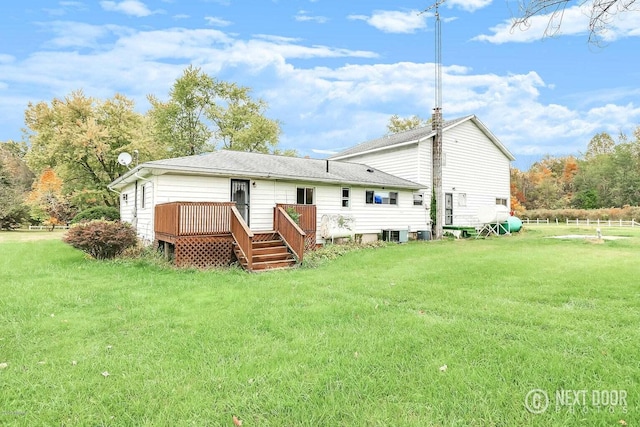 back of house featuring a lawn, cooling unit, and a deck