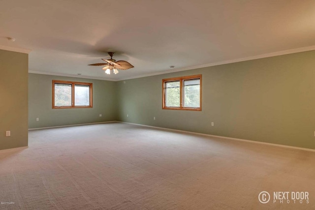 unfurnished room featuring a healthy amount of sunlight, light colored carpet, and ornamental molding