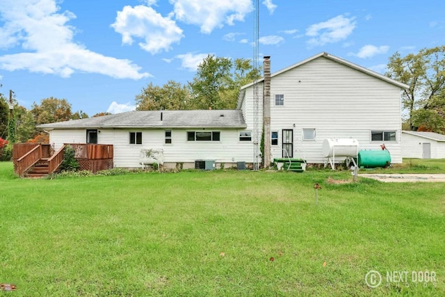 back of property with a lawn, central AC unit, and a wooden deck