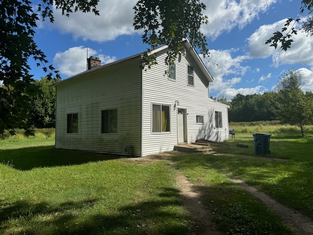 rear view of property with a yard