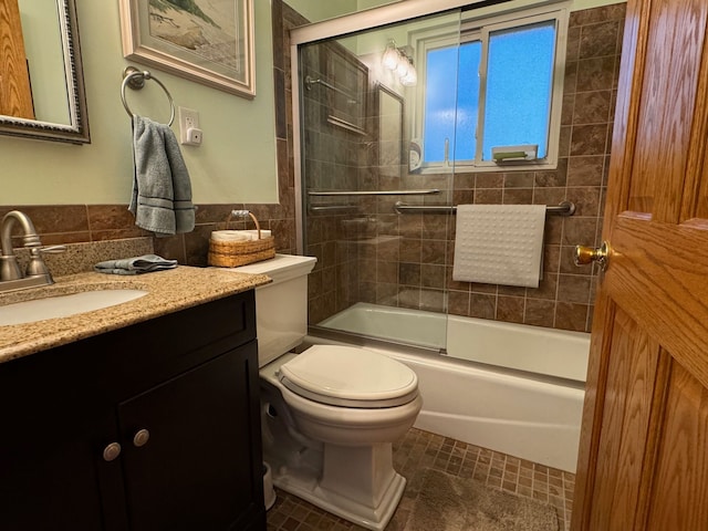 3437 3rd St Unit G, Trenton, MI 48183 - bathroom with vanity, toilet, combined bath / shower with glass door, and tile walls