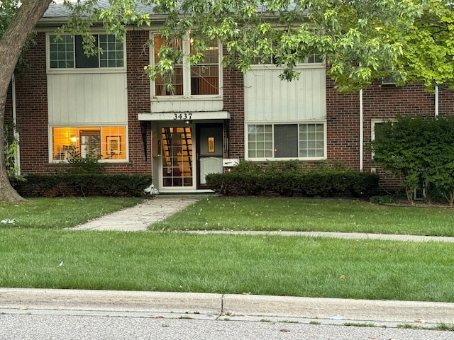 3437 3rd St Unit G, Trenton, MI 48183 - view of front of house featuring brick siding and a front lawn