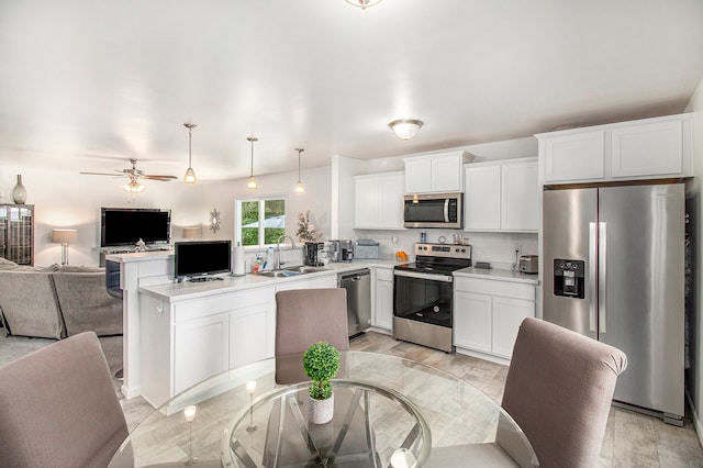 kitchen featuring sink, ceiling fan, decorative light fixtures, light hardwood / wood-style floors, and stainless steel appliances