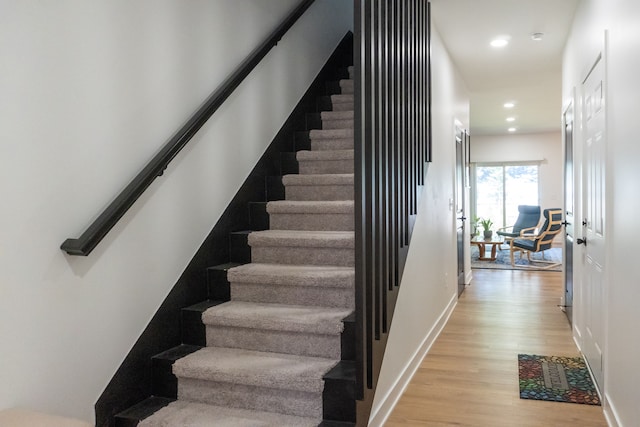 staircase featuring hardwood / wood-style flooring