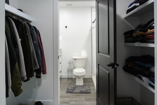 bathroom with toilet, vanity, and hardwood / wood-style flooring