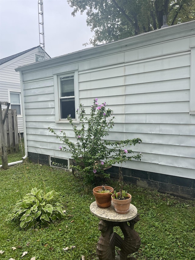 view of side of home with a yard