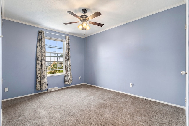 carpeted empty room featuring crown molding, ceiling fan, and a textured ceiling