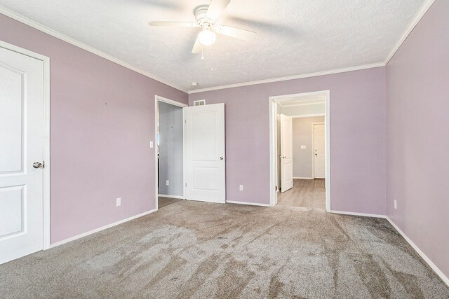 unfurnished bedroom featuring a textured ceiling, ceiling fan, crown molding, and light carpet