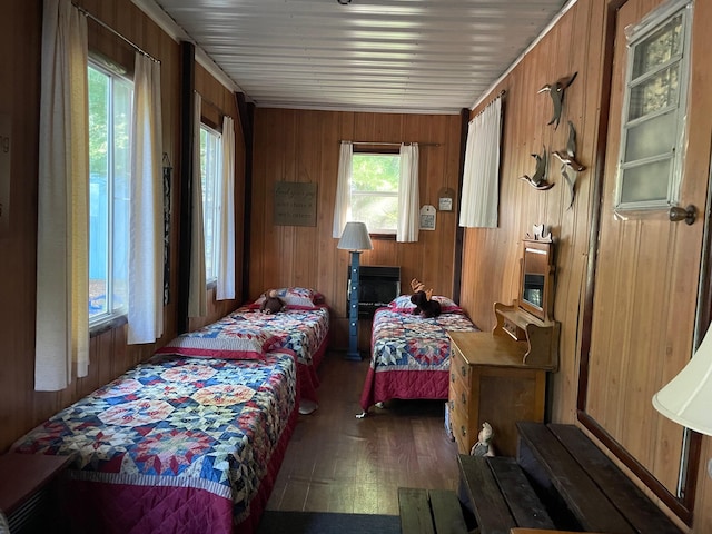 bedroom featuring dark hardwood / wood-style flooring and wood walls