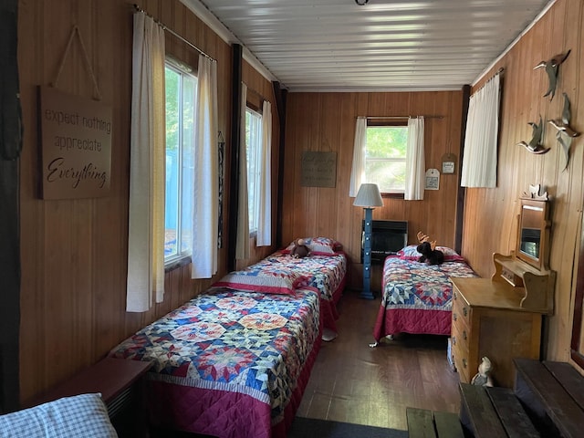 bedroom featuring wood-type flooring and wooden walls