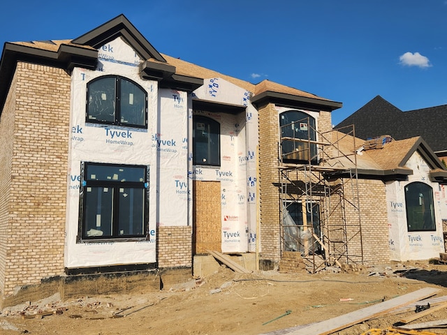 unfinished property featuring brick siding