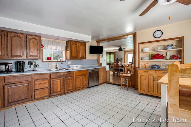 kitchen with dishwasher, light tile patterned flooring, and sink