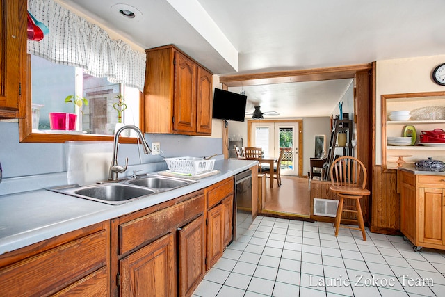 kitchen with ceiling fan, sink, light tile patterned floors, and stainless steel dishwasher