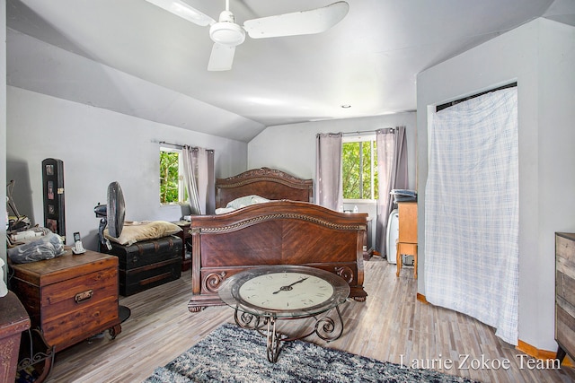 bedroom with light hardwood / wood-style floors, vaulted ceiling, and ceiling fan