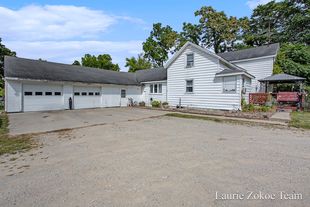 front of property with a gazebo and a garage