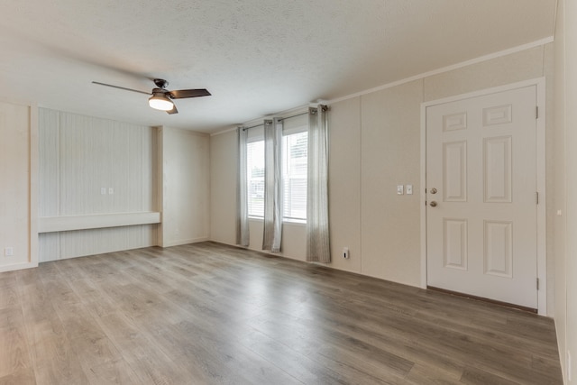 unfurnished living room with ceiling fan, wood-type flooring, and a textured ceiling