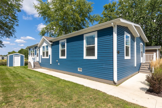 view of side of home featuring a storage shed and a yard