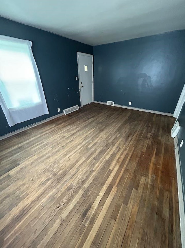 spare room with wood-type flooring