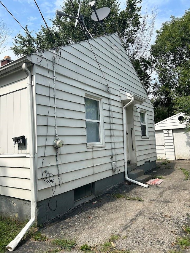 view of home's exterior with an outdoor structure