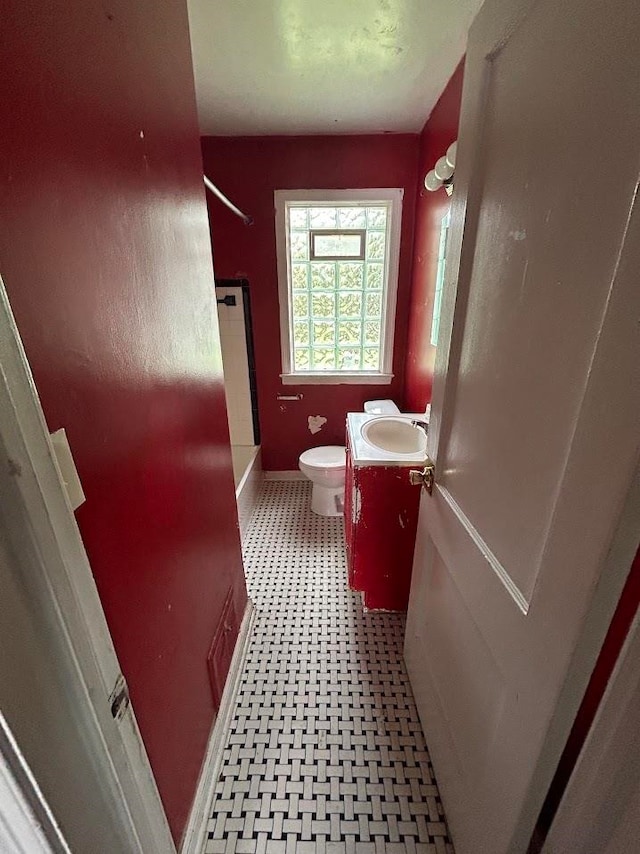 full bathroom featuring washtub / shower combination, vanity, and toilet