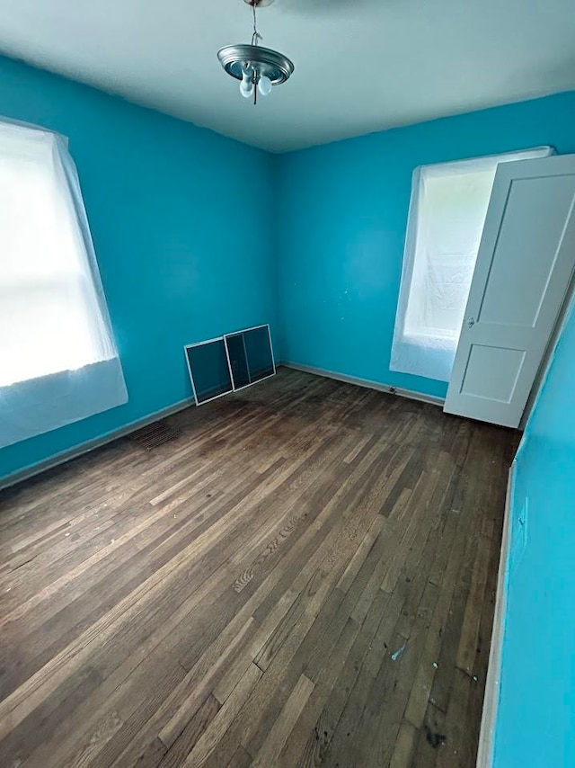 spare room featuring dark hardwood / wood-style flooring