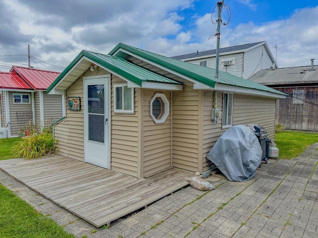 back of property featuring a wooden deck