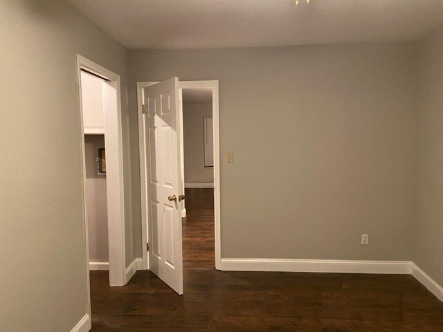 17161 Redford St Unit 203, Detroit, MI 48219 - empty room featuring baseboards and dark wood-type flooring