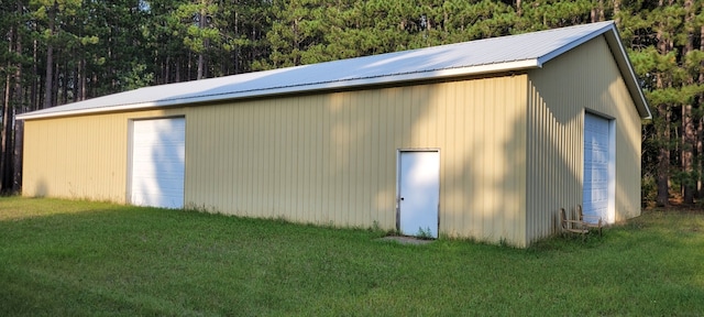 view of outbuilding featuring a yard and a garage