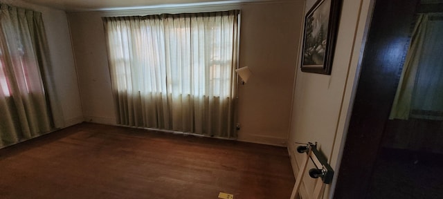 spare room featuring dark hardwood / wood-style flooring