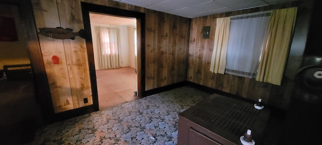 spare room with wood-type flooring and wooden walls