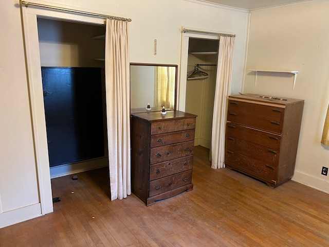 bedroom with wood-type flooring and a closet