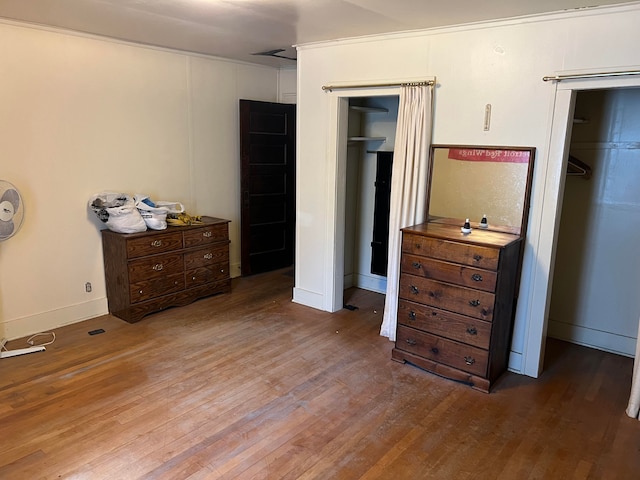 bedroom with hardwood / wood-style flooring and a closet